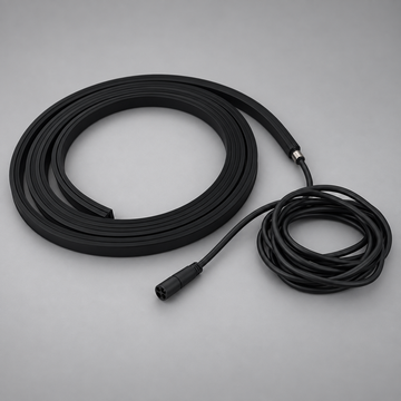 Unlit black BLAQ IRIS LED strip shown coiled with its attached connection lead