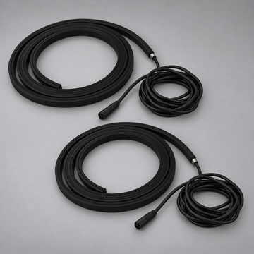 Two unlit black BLAQ IRIS LED strips shown coiled with their connection leads