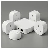 HALO Super Easy Starter smart hub with five white plug‑in adapters arranged around it