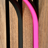 BLAQ IRIS slat-wall LED strip showing pink light between timber slats